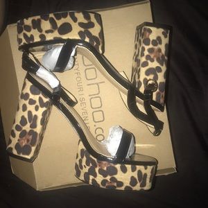 Black shoe with leopard print heel